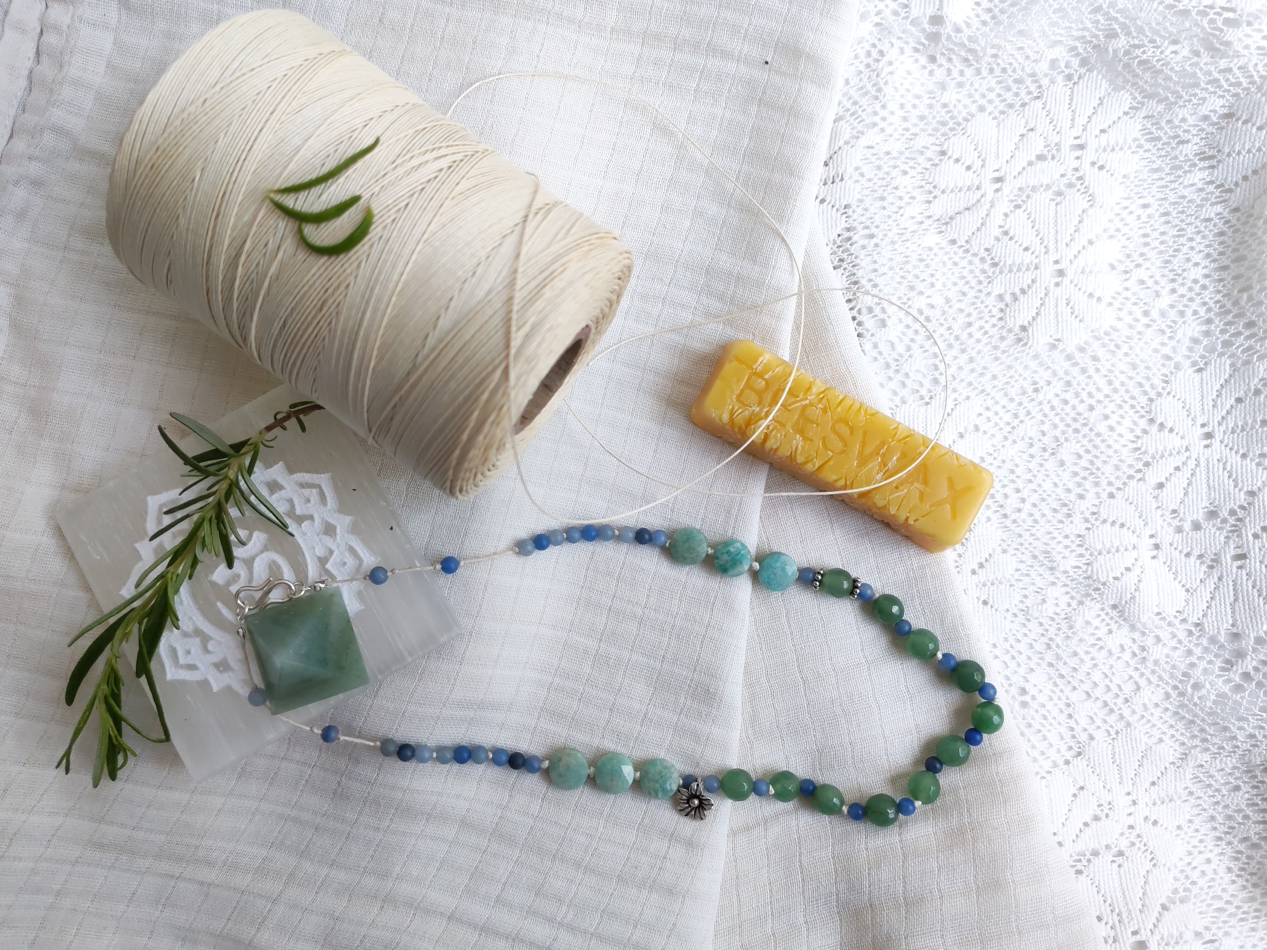 Blue and green necklace with wax and tools
